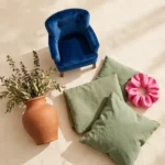 Color trends 2027 flat lay with luminous blue, clay, meadow green and pop pink home and fashion pieces