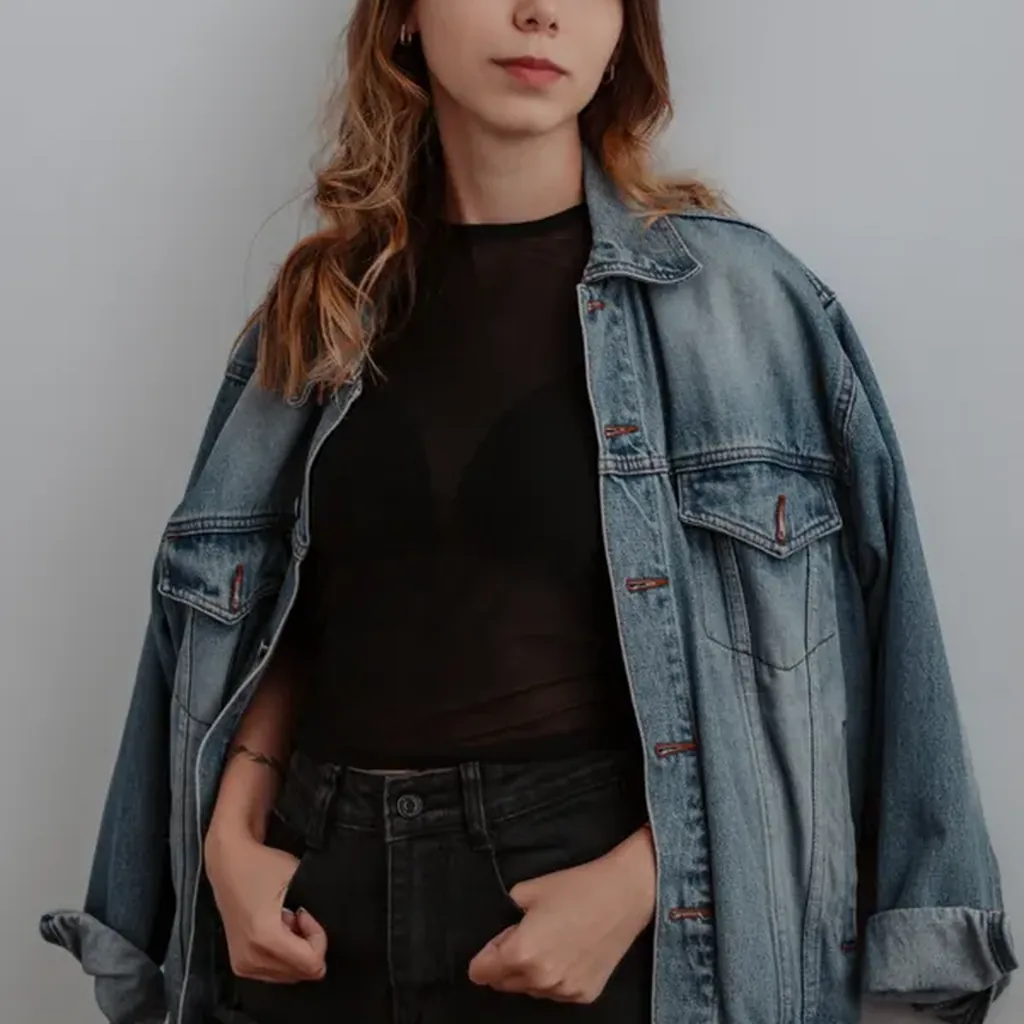 Woman wearing an oversized acid-wash denim jacket with jeans, 80s double denim outfit