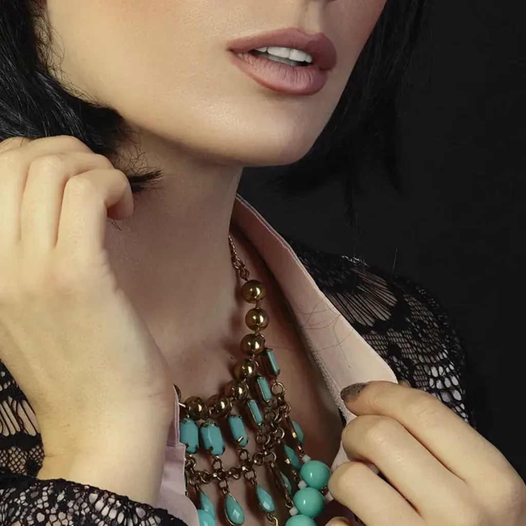Close-up of black lace with layered statement necklaces, Madonna inspired 80s outfit detail