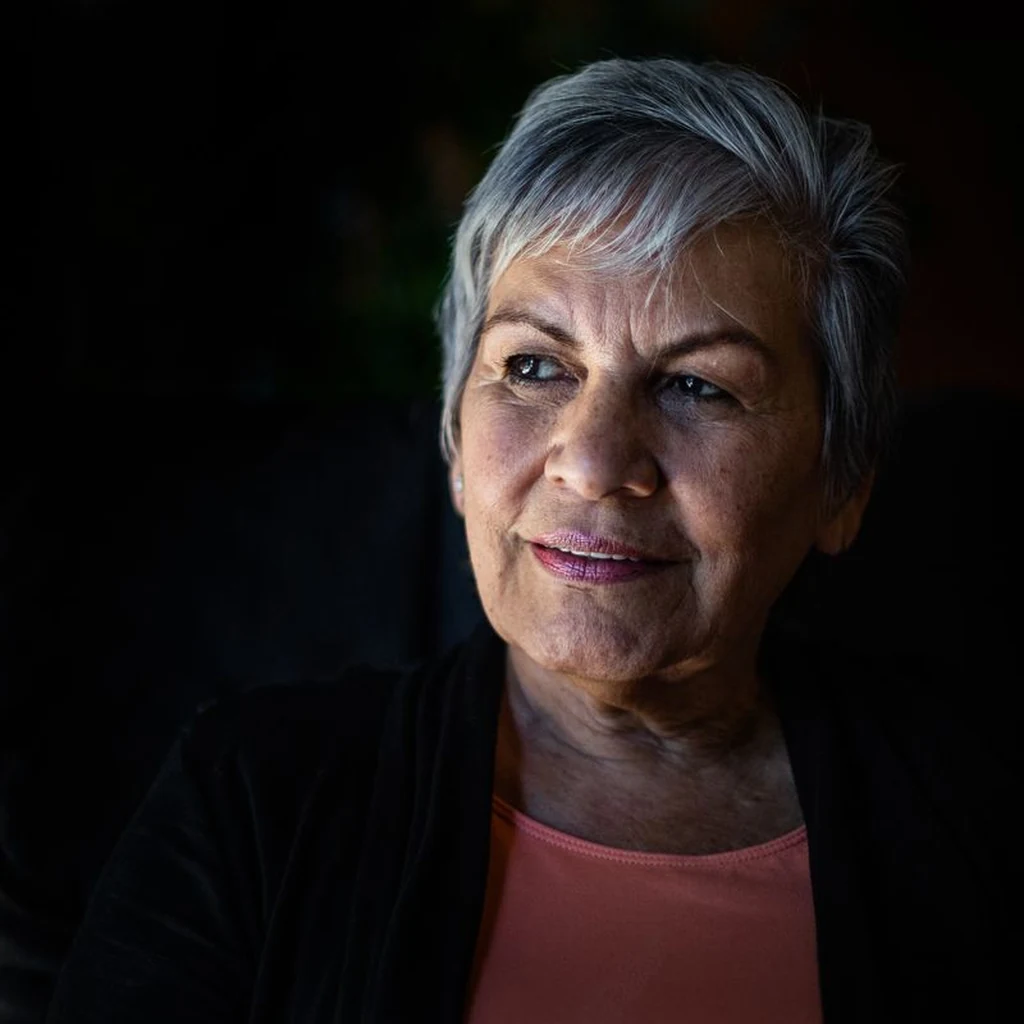 Textured silver crop haircut on a confident woman over 60