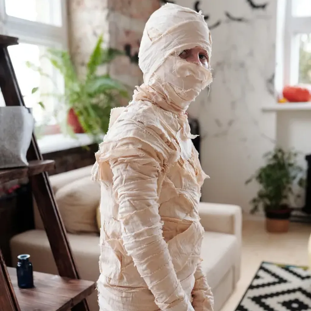 Mummy costume made from white strips wrapped over clothes