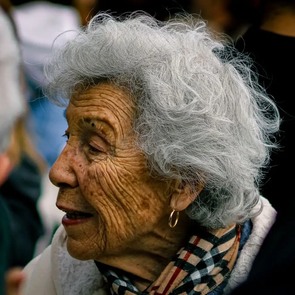 Messy feathered layers flicking outwards on a smiling woman over 60