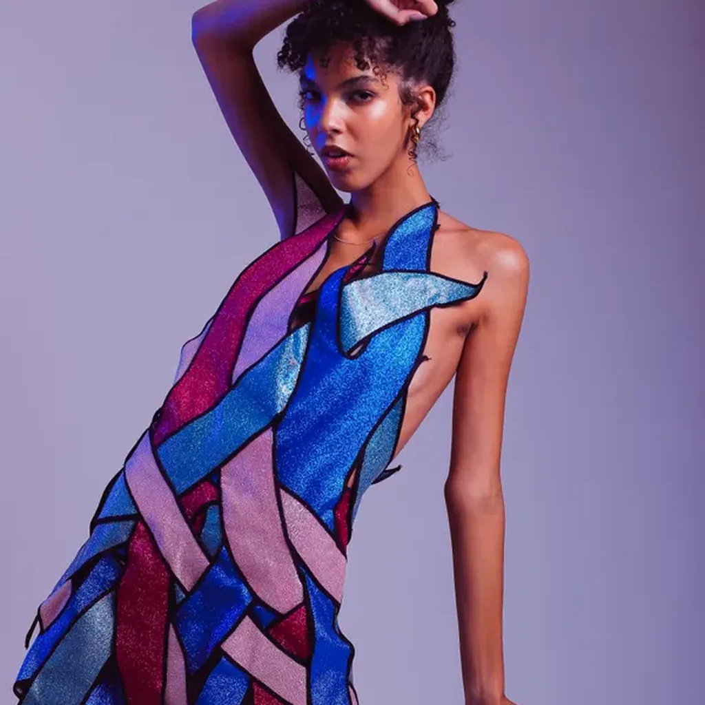 Woman in a bold colour-block dress with blue and pink panels, artistic 80s fashion