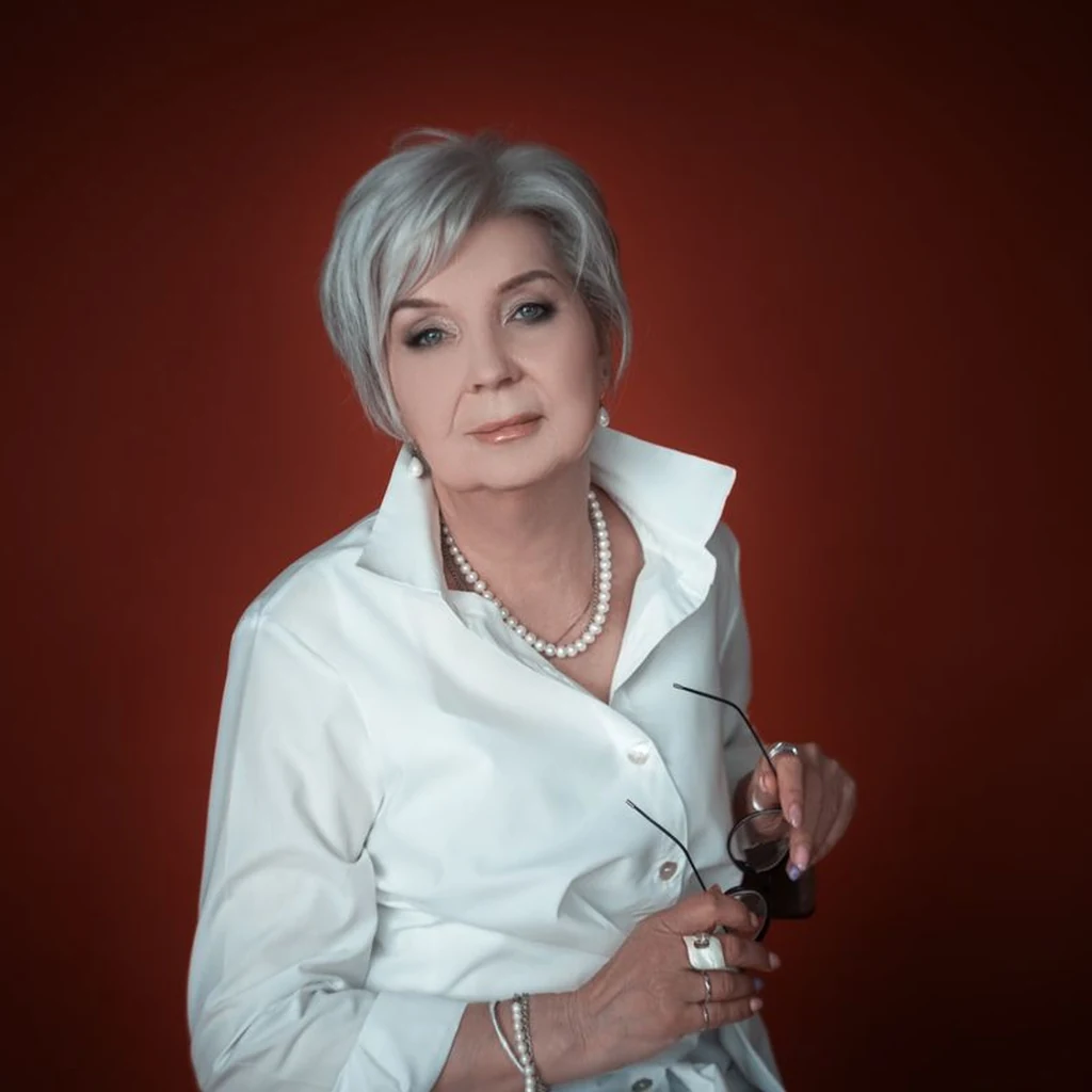 Asymmetrical messy bob, longer on one side, on a fashionable older woman