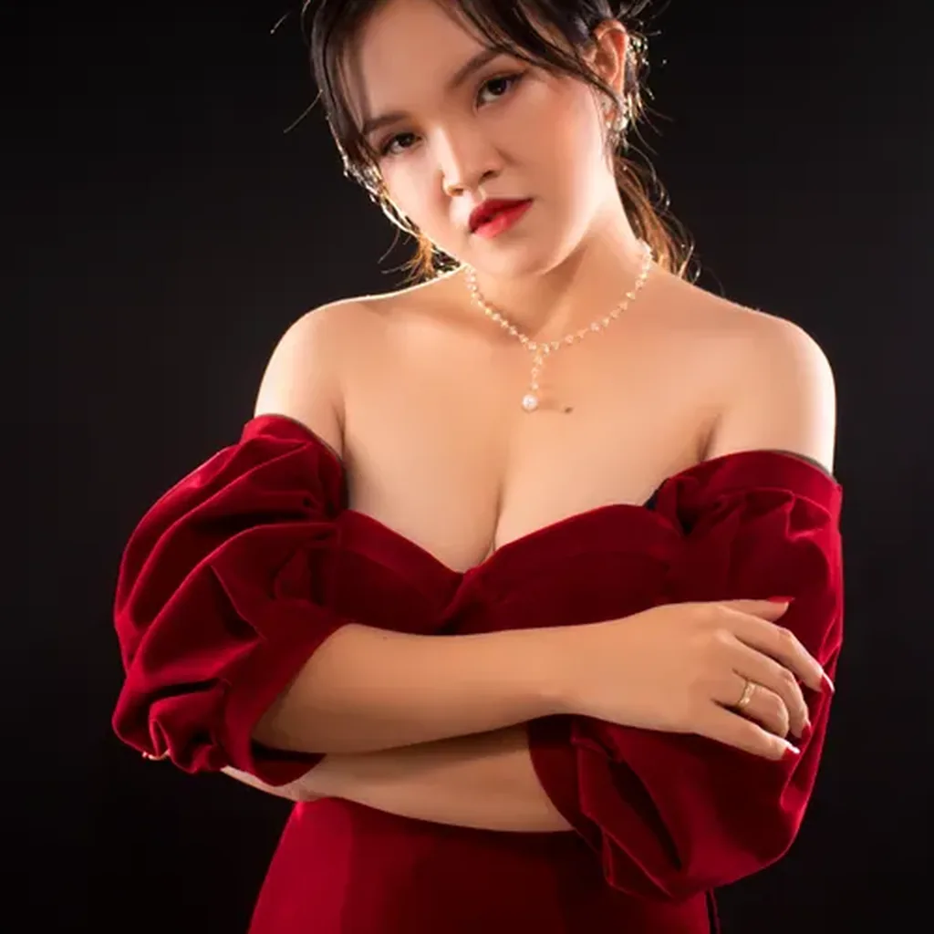 Woman in a red velvet dress with dramatic puff sleeves, romantic 80s evening outfit