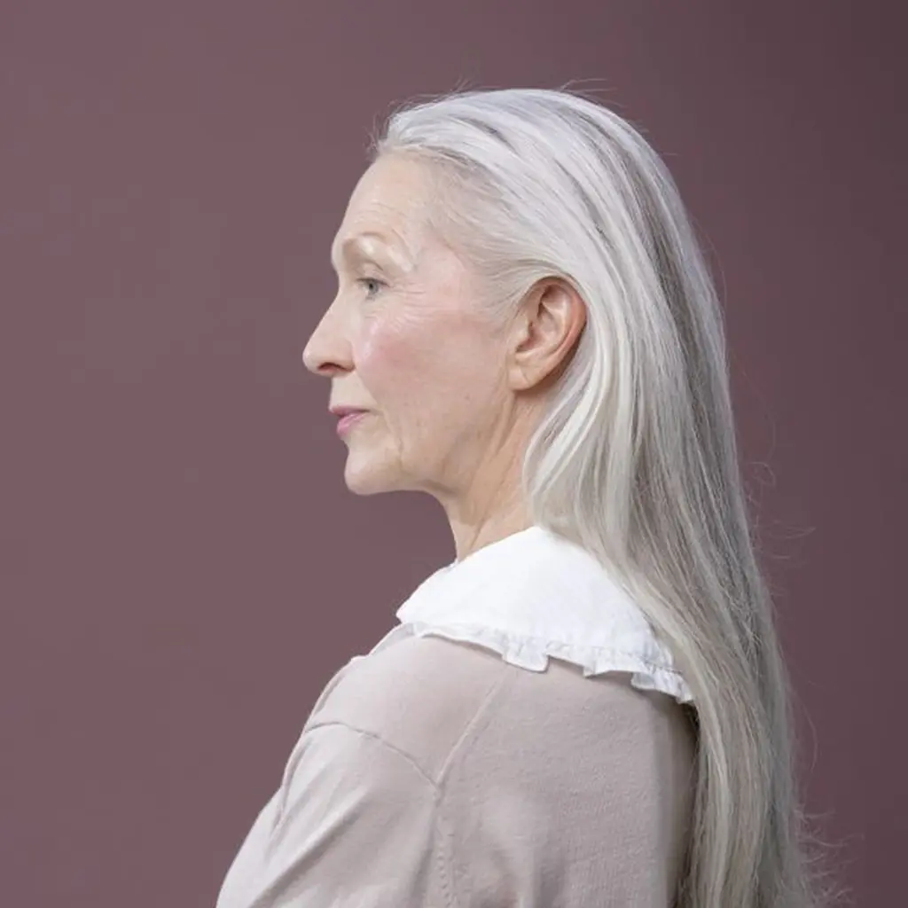 Long layers in shoulder length gray hair with a centre part