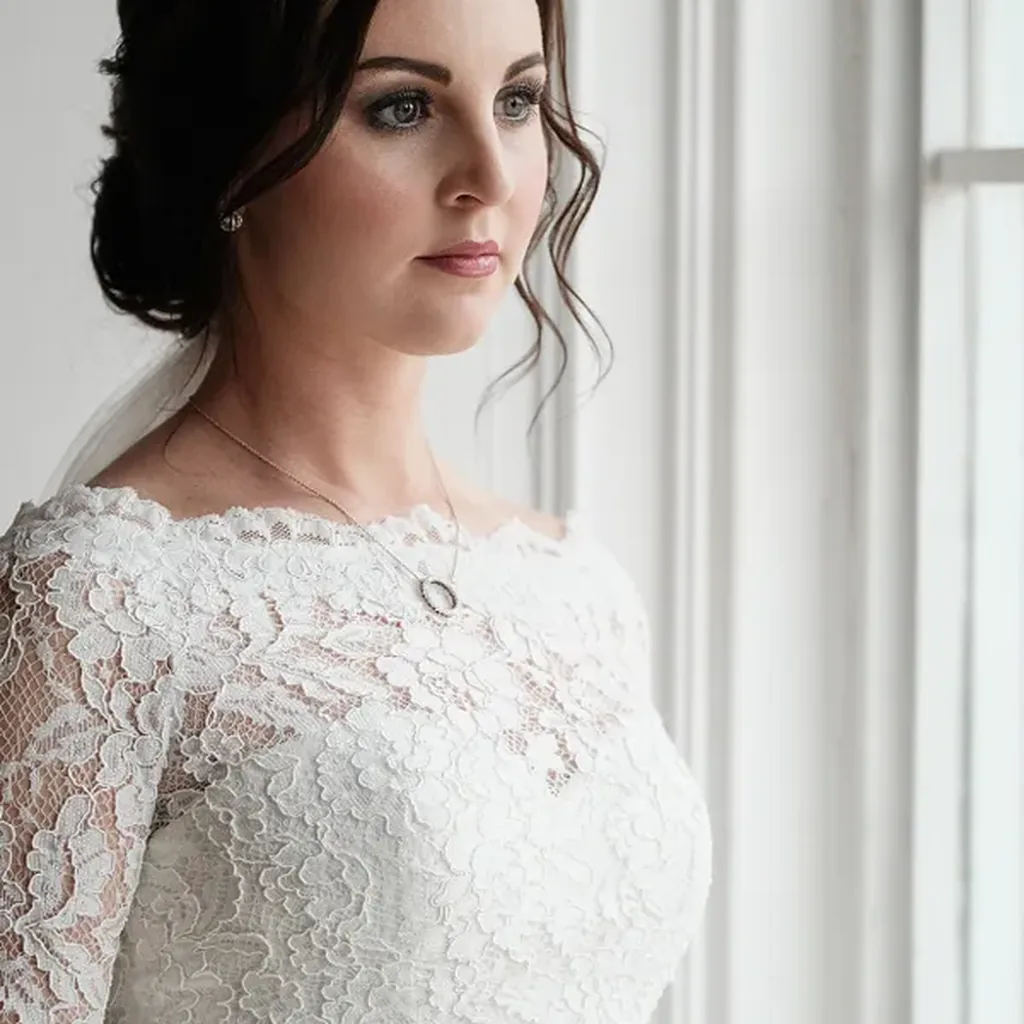 Woman in a white lace dress with long sleeves, romantic 80s bridal inspired outfit